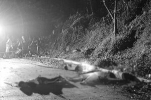 Police investigators check the bodies of four victims who were shot to death and were found on the road in Purok 9, Barangay Imelda, Villanueva town in Misamis Oriental Sunday dawn, July 10. (Photo courtesy of Cyril Cambalon Jr.) 