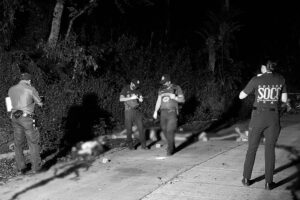 Police investigators check the bodies of four victims who were shot to death and were found on the road in Purok 9, Barangay Imelda, Villanueva town in Misamis Oriental Sunday dawn, July 10. (Photo courtesy of Cyril Cambalon Jr.) 