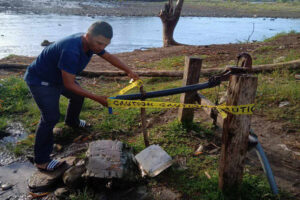 UNSAFE. A municipal health personnel cordons off Tuesday (Jan. 2, 2024) one of the four water pumps to prevent residents from taking drinking water after a diarrhea outbreak that left five dead in Talayan, Maguindanao del Sur since Dec. 31, 2023. The communal water pumps are situated near the Talayan River in Barangay Tamar of Talayan where locals dump their garbage and dispose of human waste, among others. (Photo from Talayan MDRRMO)