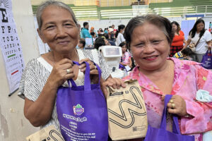 Beneficiaries receive medicine and other items from Watsons after receiving medical services offered at the medical mission