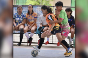 TOP SCORER. NMRAA Regional Girls Futsal top scorer Norjean Palatis defends the ball against Lumbia National High School defender Rose Marie Pagalan in their tune-up match for the Palarong Pambansa at the Bulua gym. (Photo by Kjay Francisco Edorot)
