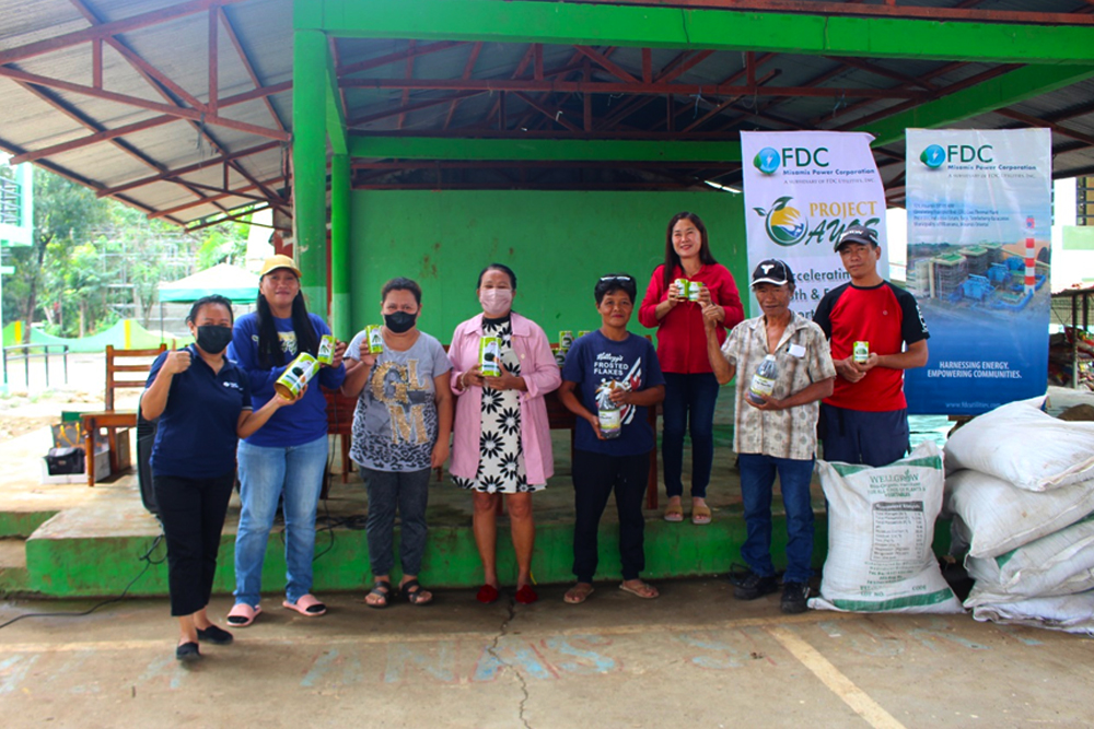 Photo shows, from left, FDC Misamis’ Analiza Miso, Cor. Comm. & External Affairs Manager, and representatives of Balacanas Fisherfolks Association, headed by Hon. Nila Pagaling, Punong Barangay of Balacanas, during the ceremonial turnover. (Photo supplied)