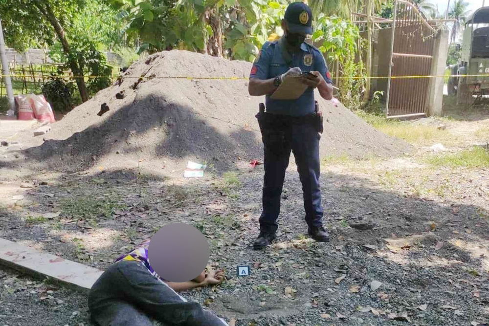 GUNNED DOWN. Police officers conduct a site investigation on the murder of a 21-year-old student inside the Datu Dalandag National High School compound in Pikit, North Cotabato, on Wednesday (Nov. 29, 2024). The victim was also a member of the Civilian Armed Forces Geographical Unit, according to the police. (Photo courtesy of Pikit MPS)