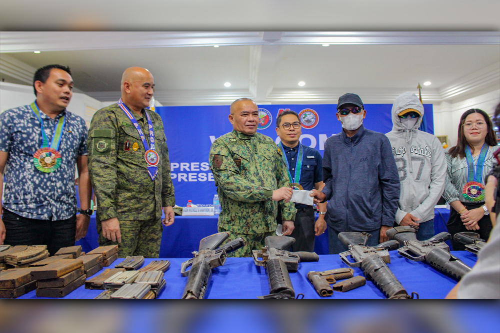 Two former rebels receive cash rewards for their instrumental role in discovering and retrieving a cache of firearms in Bukidnon. (JAKA/PIA10)