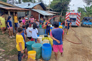 Residents of Sitio Laruk, Barangay Kisolon of Sumilao, Bukidnon waiting their empty water containers be filled with water from firetruck of their Municipal Fire Station, January 13, 2024. [Photo courtesy of BFP MFS Kisolon]