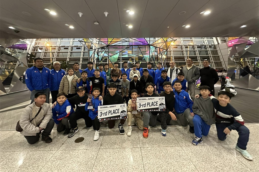 FUTURE STARS – Thirty young basketeers, composed of 15 years old and under, most of them from Cagayan de Oro and Northern Mindanao, with their coaching staff and chaperons pose after the awarding rites on Sunday, February 18, of the 2024 Asian Basketball Club Tournament in Hongcheon, South Korea. [Photo courtesy of Patsada-CDO Sports Promotions via Evolve XT] HOTLY CONTESTED - The distinctively designed crimson-colored 2024 Asian (Basketball) Supercup Trophy. [Evolve XT Photo]