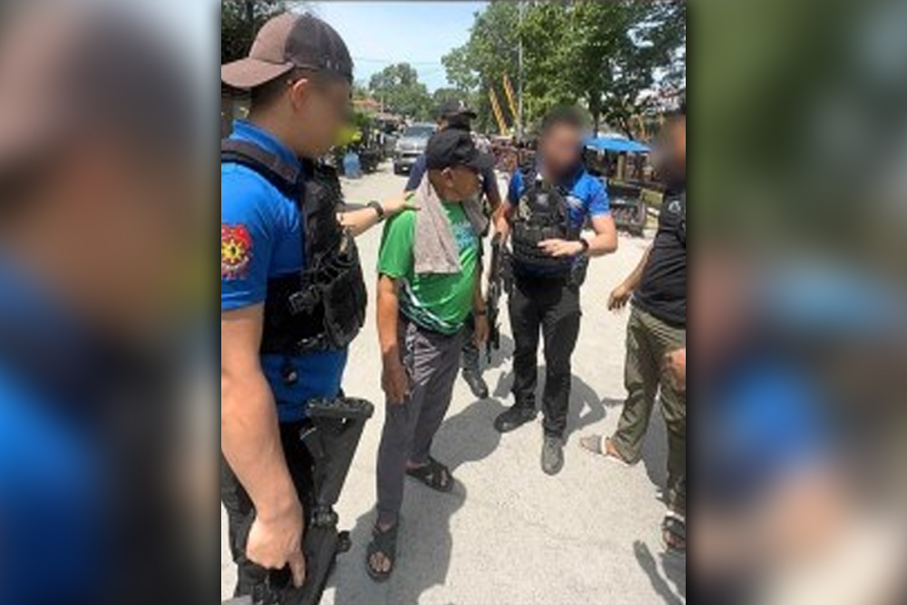 NABBED. A senior field leader of the outlawed Bangsamoro Islamic Freedom Fighters is arrested in Datu Piang, Maguindanao del Sur on Wednesday (June 5, 2024). Although armed with a .45-caliber pistol, Abunawas Ibad Damiog (in green shirt) did not resist arrest. (Photo courtesy of CIDG-BARMM)